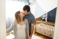 The Parents standing In Nursery With Baby son