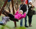 Parents swinging children at park