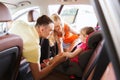 Parents talking to little girl in baby car seat Royalty Free Stock Photo