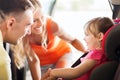 Parents talking to little girl in baby car seat Royalty Free Stock Photo