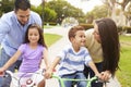 Parents Teaching Children To Ride Bikes In Park Royalty Free Stock Photo