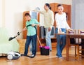 Parents with teenage son doing house cleaning Royalty Free Stock Photo