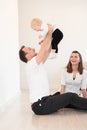 Parents and their beautiful baby girl sitting on the ground and playing. Royalty Free Stock Photo