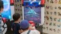 Parents with their children playing Pokemon branded arcade video games at Pokemon Center, Tokyo, Japan Royalty Free Stock Photo