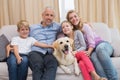 Parents and their children on sofa with labrador Royalty Free Stock Photo