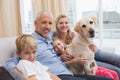 Parents and their children on sofa with labrador Royalty Free Stock Photo