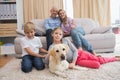 Parents and their children on sofa with labrador Royalty Free Stock Photo