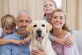 Parents and their children on sofa with labrador Royalty Free Stock Photo