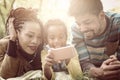 African American parents with their daughter in park using mobil Royalty Free Stock Photo