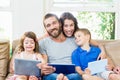 Parents with their kids using laptop and digital tablet Royalty Free Stock Photo