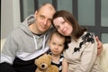 Parents and their little daughter sitting on sofa Royalty Free Stock Photo