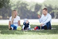 Parents and their little son blowing bubbles on a summer day walk. Royalty Free Stock Photo