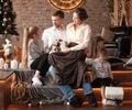 Parents with their young children sitting in the living room decorated for Christmas Royalty Free Stock Photo