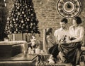 parents with their young children sitting in the living room decorated for Christmas. black and white photo Royalty Free Stock Photo