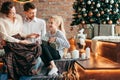 Parents with their young children sitting in the living room decorated for Christmas Royalty Free Stock Photo