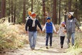 Parents and three children walking in a forest, front view Royalty Free Stock Photo