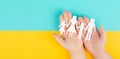 Parents with two child holding hands, family life, paper cut out, copy space, yellow and blue colored background, relationship Royalty Free Stock Photo