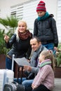 Parents with two kids and baggage with map