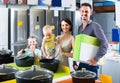 parents with two kids choosing kitchenware in home appliance store Royalty Free Stock Photo