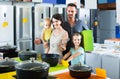 parents with two kids choosing kitchenware in home appliance store Royalty Free Stock Photo