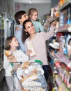 Parents with two kids holding purchases in store Royalty Free Stock Photo