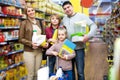 Parents with two kids holding purchases in store Royalty Free Stock Photo