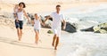 Parents with two kids jogging on beach Royalty Free Stock Photo