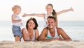 Parents with two kids lying on the beach. Royalty Free Stock Photo
