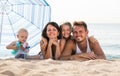 Parents with two kids lying on the beach Royalty Free Stock Photo