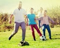 Parents with two kids playing soccer Royalty Free Stock Photo