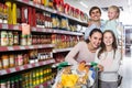 parents with two kids and purchases in shopping cart Royalty Free Stock Photo