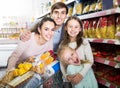 Parents with two kids and purchases in shopping cart Royalty Free Stock Photo