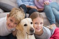 Parents watching children on rug with labrador Royalty Free Stock Photo