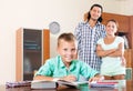 Parents watching their son doing homework Royalty Free Stock Photo