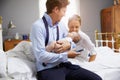 Parents With Young Baby Dressing For Work In Bedroom Royalty Free Stock Photo