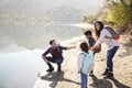 Parents with young children exploring beside a mountain lake Royalty Free Stock Photo