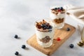 Parfait. Glasses with homemade granola with yogurt and fresh berries on white concrete background. Dieting, recipe. Side view, Royalty Free Stock Photo