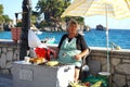 Parga, Greece, July 17 2018 An elderly lady sells cobs of roasted corn