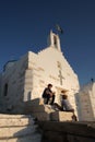 Parikia, Greece, September 16 2018, Greek children play near the church of Agios Konstantinou, a traditional Cycladic church Royalty Free Stock Photo