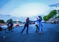 3 American young woman roller skating in Paris on left riverbank of Seine