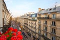 Paris, ancient buildings facades and street in a summer sunset in France