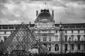 paris, august 2023. the glass pyramid of the louvre and the louvre museum with its visitors and tourists