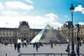 paris, august 2023. the glass pyramid of the louvre and the louvre museum with its visitors and tourists