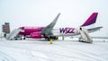 Paris Beauvais, France - 22.01.2019: Snow in International airport Beauvais. Airplane near terminal gate ready for takeoff Royalty Free Stock Photo