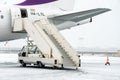 Paris Beauvais, France - 22.01.2019: Snow in International airport Beauvais. Airplane near terminal gate ready for takeoff Royalty Free Stock Photo