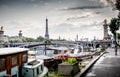 Paris, boats and barges with view on the Eiffel Tower and the Bridge Alexandre III, between the quai d`orsay and the Grand Palais