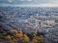 Paris cityscape view from the Eiffel tower height, France. Fall season scene with colored trees