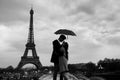 Paris, couple under umbrella near Eiffel tower Royalty Free Stock Photo