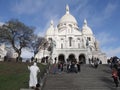 Paris 20 December 2018. Montmartre. Sacre-Coeur Basilica. On the steps are tourists and working mimes Royalty Free Stock Photo