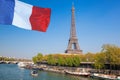 Paris with Eiffel Tower against french flag during spring time in France Royalty Free Stock Photo